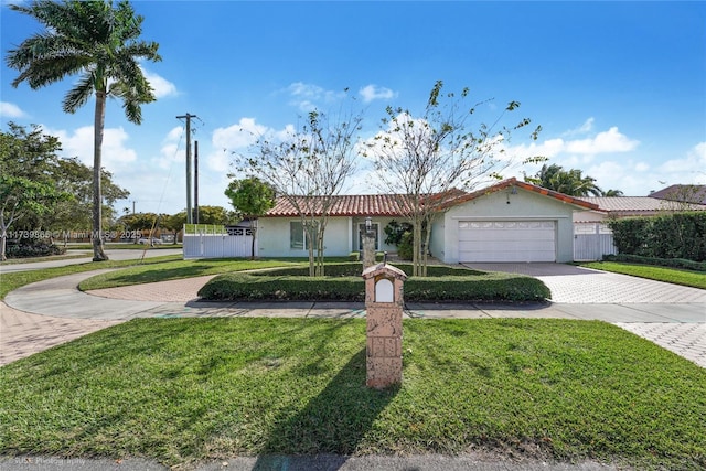 ranch-style house with a garage and a front yard