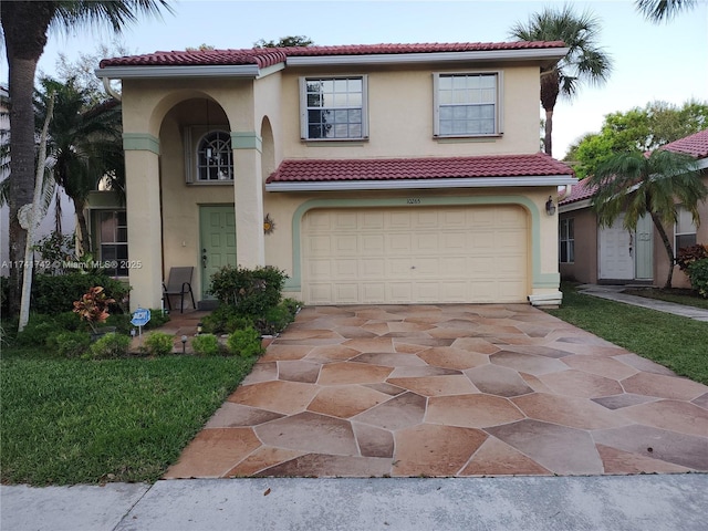 10265 N Serene Meadow Dr N, Boca Raton, FL 33428 - mediterranean / spanish-style house with an attached garage, a tiled roof, stucco siding, and concrete driveway