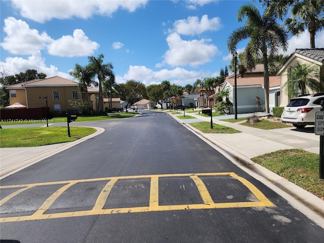 view of road featuring a residential view and curbs