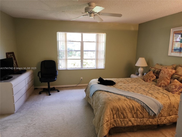 bedroom featuring a ceiling fan, light colored carpet, a textured ceiling, and baseboards