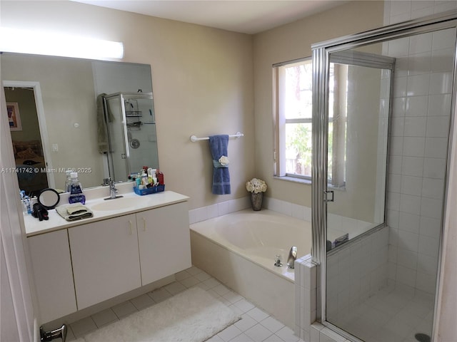 ensuite bathroom featuring a garden tub, a stall shower, connected bathroom, vanity, and tile patterned flooring