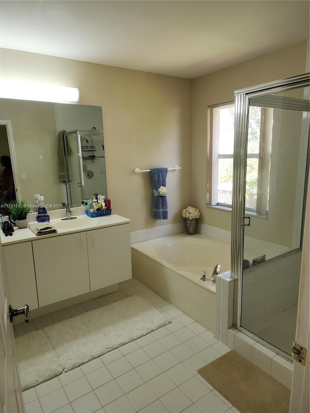 bathroom with a garden tub, a shower stall, vanity, and tile patterned floors