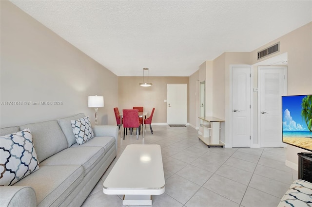 living room featuring light tile patterned floors and a textured ceiling