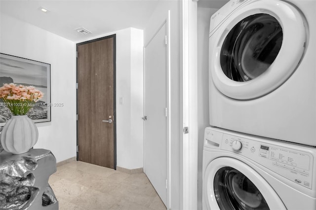 washroom featuring stacked washer / dryer