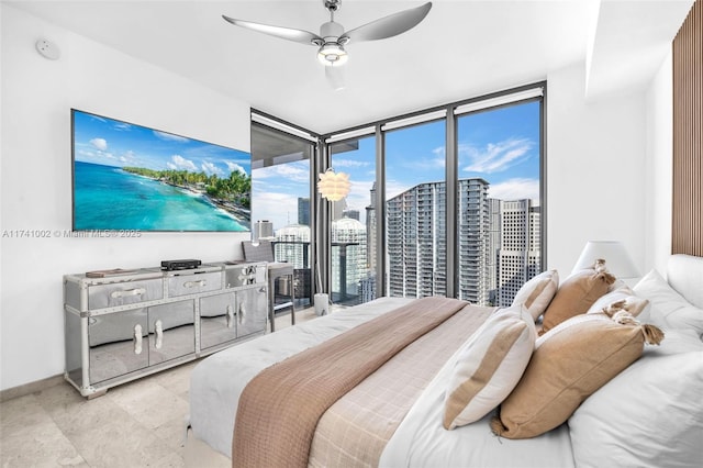 bedroom featuring ceiling fan, a wall of windows, baseboards, and access to exterior