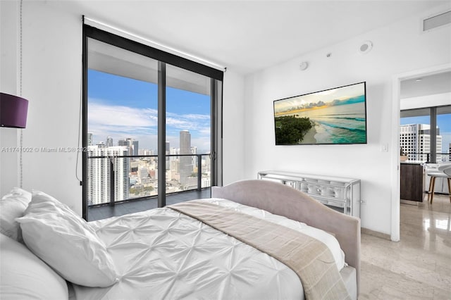 bedroom with access to outside, expansive windows, and visible vents