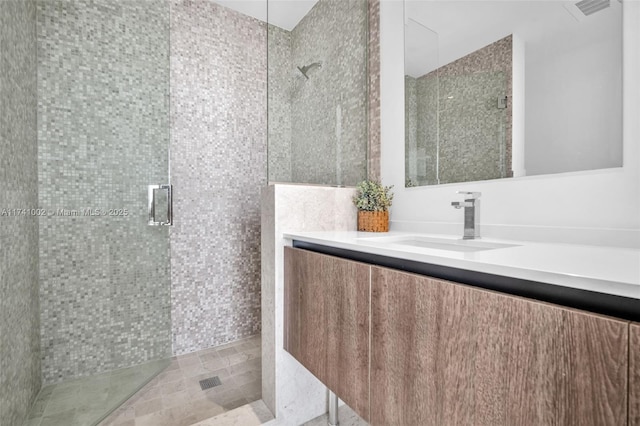 full bath featuring visible vents, a shower stall, and vanity