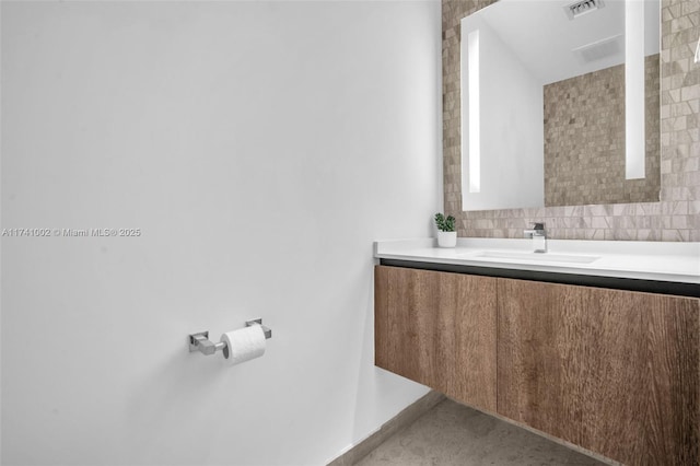 bathroom featuring tasteful backsplash, vanity, and visible vents