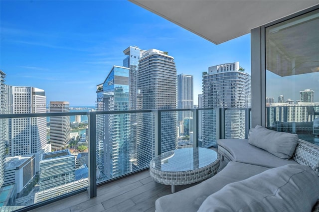 balcony with a city view and an outdoor hangout area