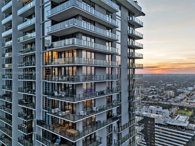 property at dusk with a city view