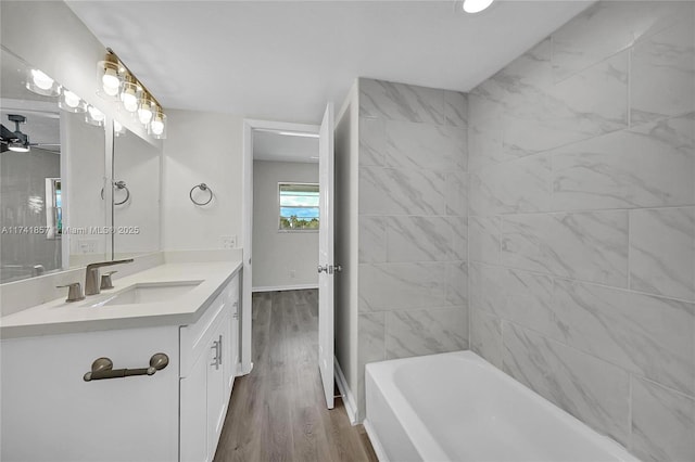 bathroom with vanity, tiled shower / bath combo, and hardwood / wood-style floors