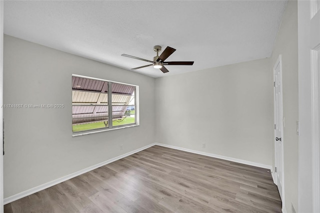 spare room with hardwood / wood-style floors, a textured ceiling, and ceiling fan