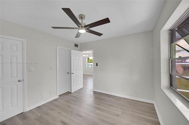 unfurnished room featuring light hardwood / wood-style floors and ceiling fan