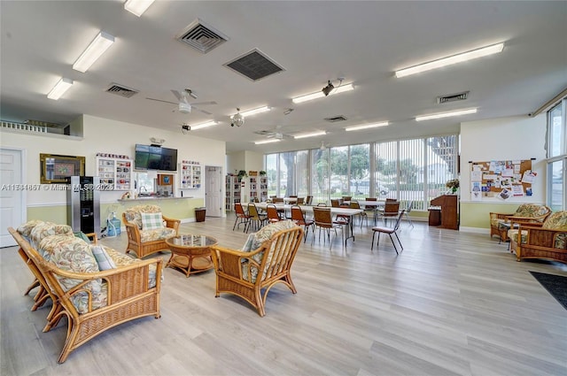 living room with ceiling fan and light wood-type flooring