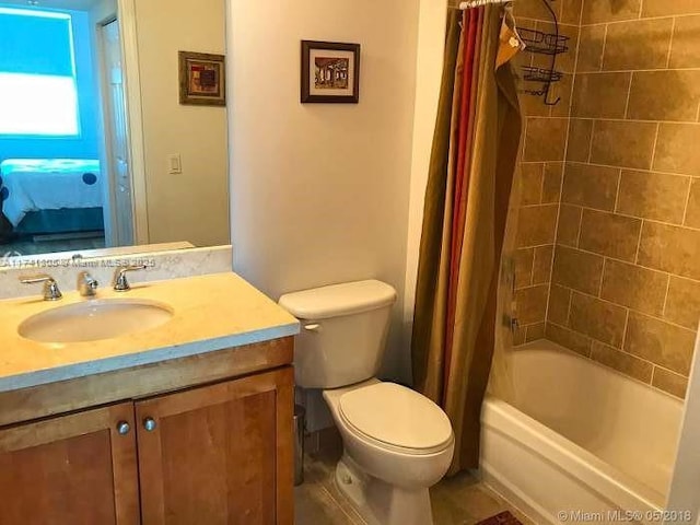 full bathroom featuring vanity, shower / bath combo, and toilet