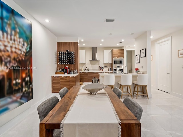 tiled dining area featuring indoor bar