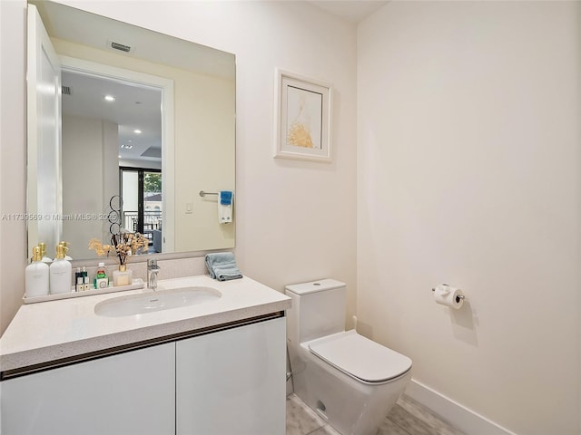 bathroom with vanity and toilet