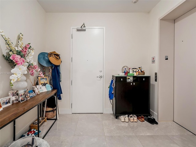 foyer entrance featuring light tile patterned flooring