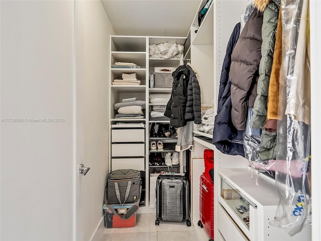 spacious closet with light tile patterned floors