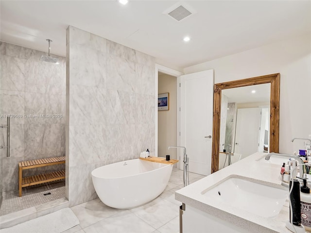 bathroom with vanity, plus walk in shower, and tile walls