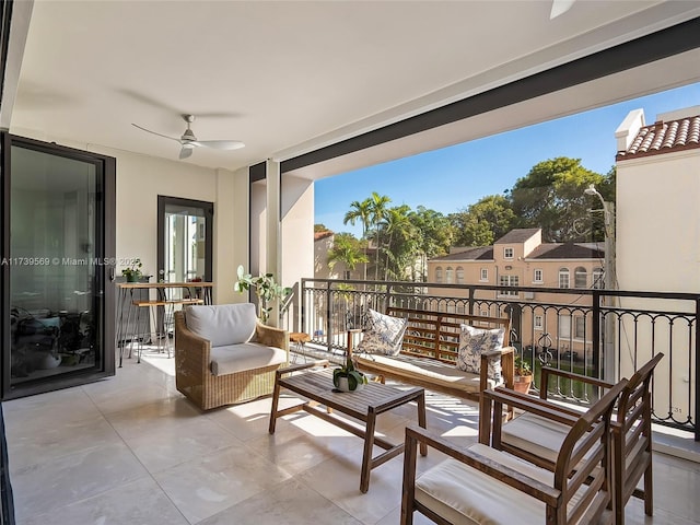 balcony with outdoor lounge area, ceiling fan, and a patio area