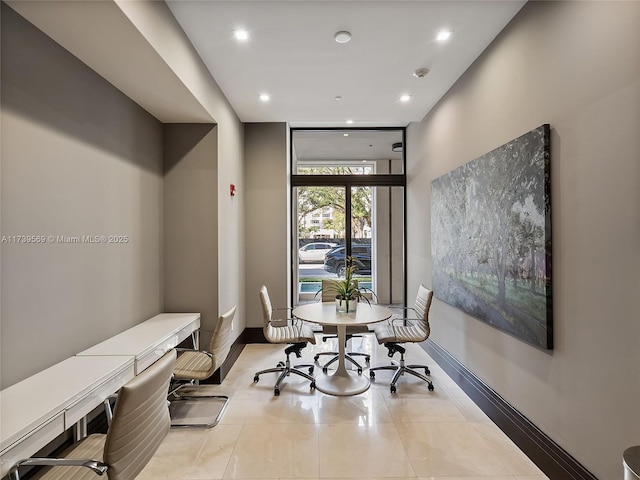 dining room with light tile patterned floors and a wall of windows