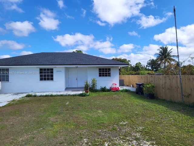 back of house with a lawn