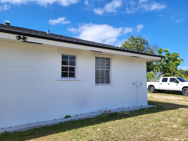 view of side of home featuring a yard