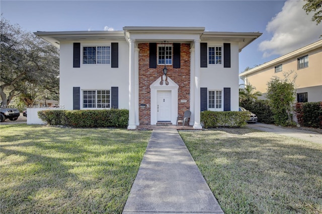 neoclassical / greek revival house with a front yard