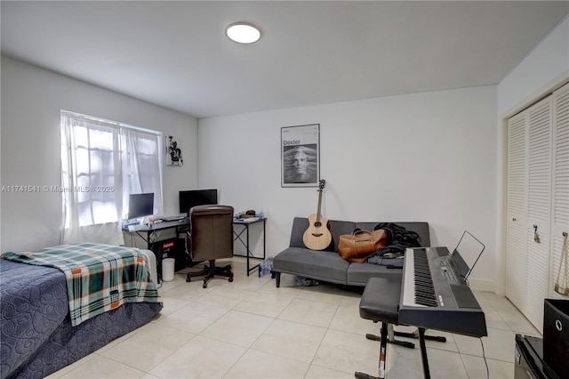 bedroom with a closet and light tile patterned floors