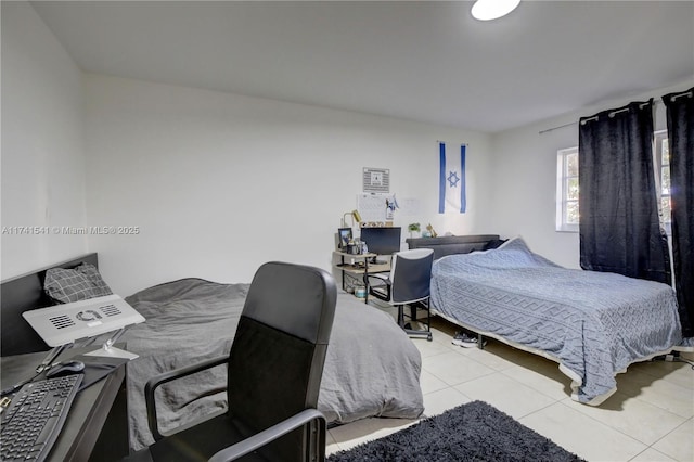 bedroom with light tile patterned floors