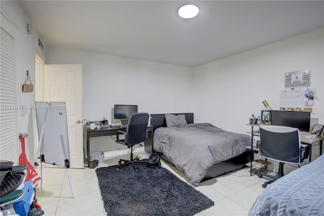 bedroom with light tile patterned floors