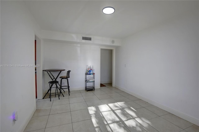 unfurnished room with light tile patterned floors