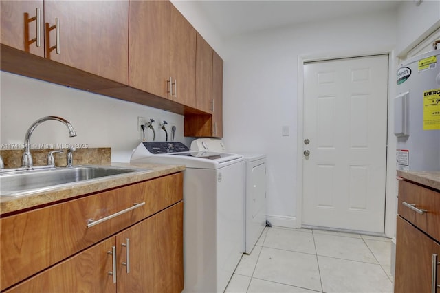 washroom with sink, cabinets, washer and dryer, and light tile patterned flooring