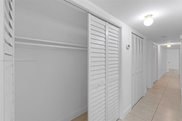 hall featuring light tile patterned flooring