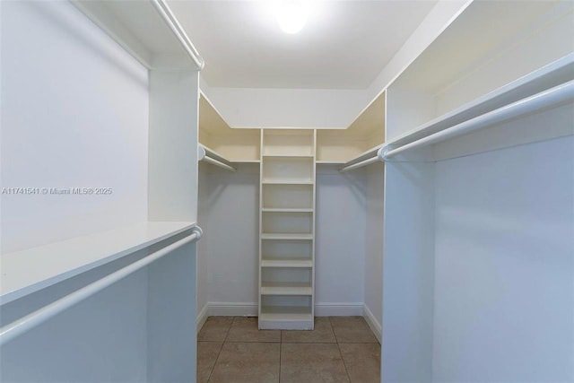 walk in closet featuring light tile patterned flooring