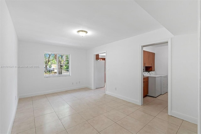 tiled empty room with separate washer and dryer