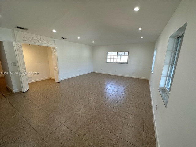 unfurnished room with tile patterned floors