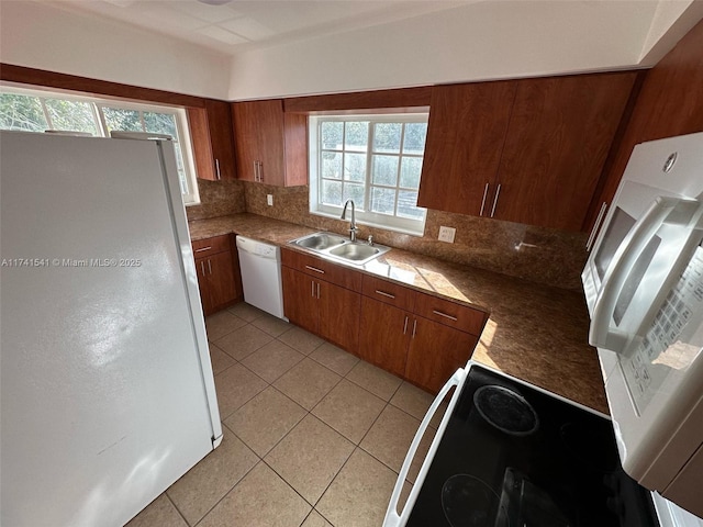 kitchen with white appliances, sink, decorative backsplash, and light tile patterned floors