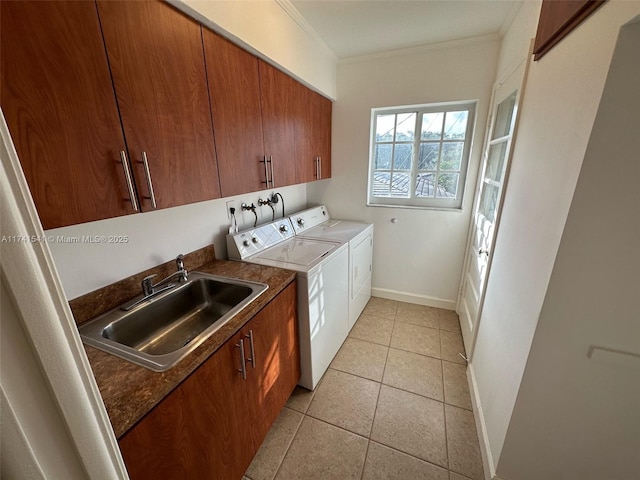 laundry room with cabinets, washing machine and clothes dryer, ornamental molding, and sink