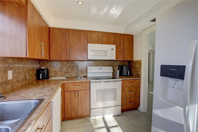 kitchen featuring tasteful backsplash, white appliances, sink, and light tile patterned floors