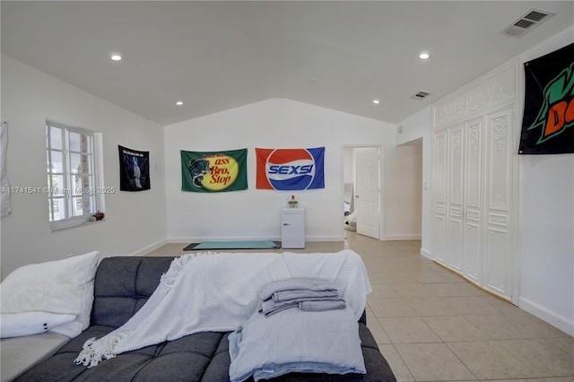 bedroom featuring light tile patterned flooring and lofted ceiling