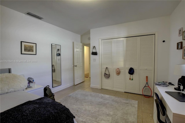 bedroom with light tile patterned flooring and a closet