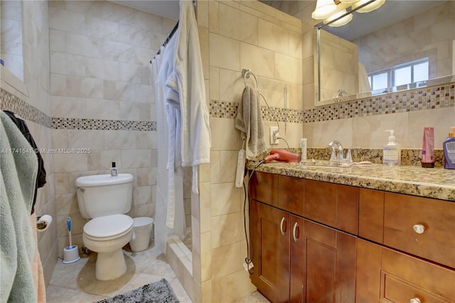 bathroom featuring vanity, tile walls, tile patterned floors, and walk in shower