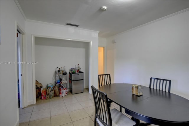 tiled dining room with ornamental molding