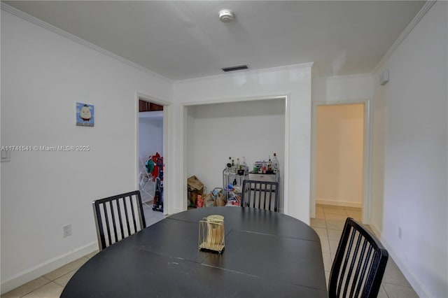 dining space with crown molding and light tile patterned flooring