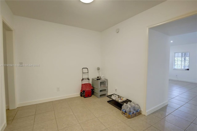 unfurnished room with light tile patterned floors