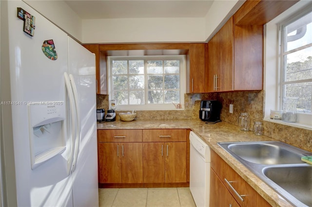 kitchen featuring white appliances, sink, decorative backsplash, and light tile patterned floors