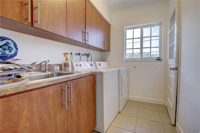 washroom featuring light tile patterned flooring, sink, crown molding, cabinets, and separate washer and dryer