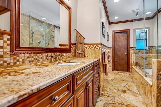 bathroom featuring ornamental molding, shower with separate bathtub, and vanity